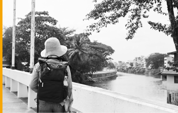 Hypothetical Vectibix patient wearing a backpack and watching a view with water
