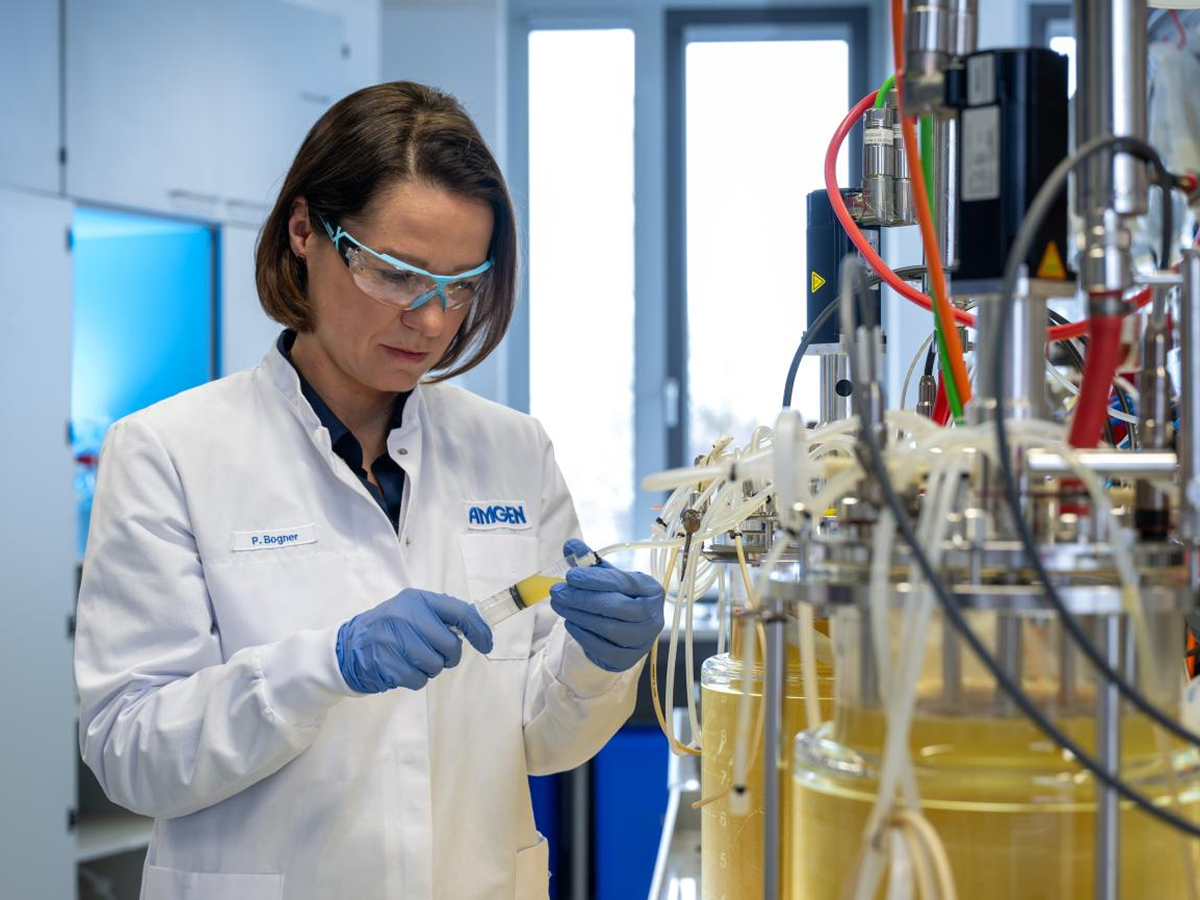 An Amgen researcher testing liquid in a tube